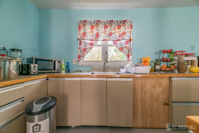 185 Redmond St, New Brunswick, NJ 08901 - kitchen featuring stainless steel microwave, a sink, and light countertops