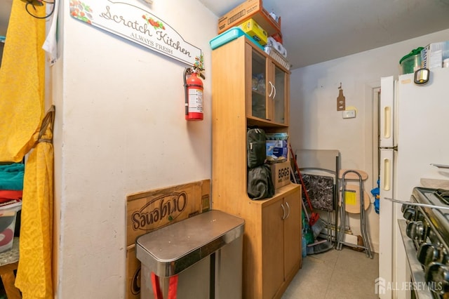 185 Redmond St, New Brunswick, NJ 08901 - kitchen with gas range, light tile patterned floors, and glass insert cabinets