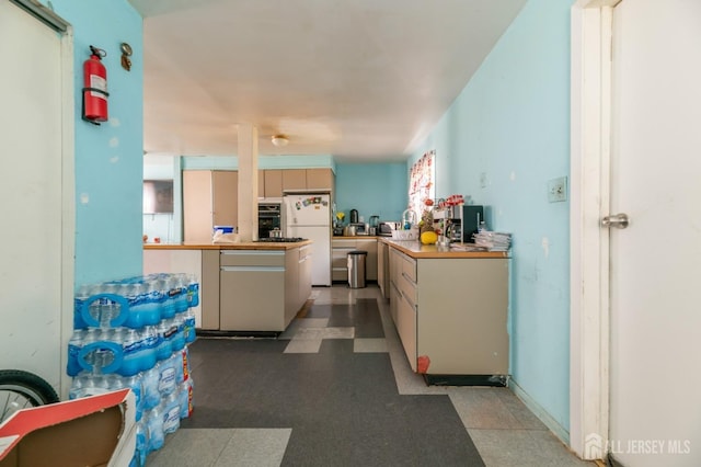 185 Redmond St, New Brunswick, NJ 08901 - kitchen with freestanding refrigerator, black oven, tile patterned floors, and light countertops
