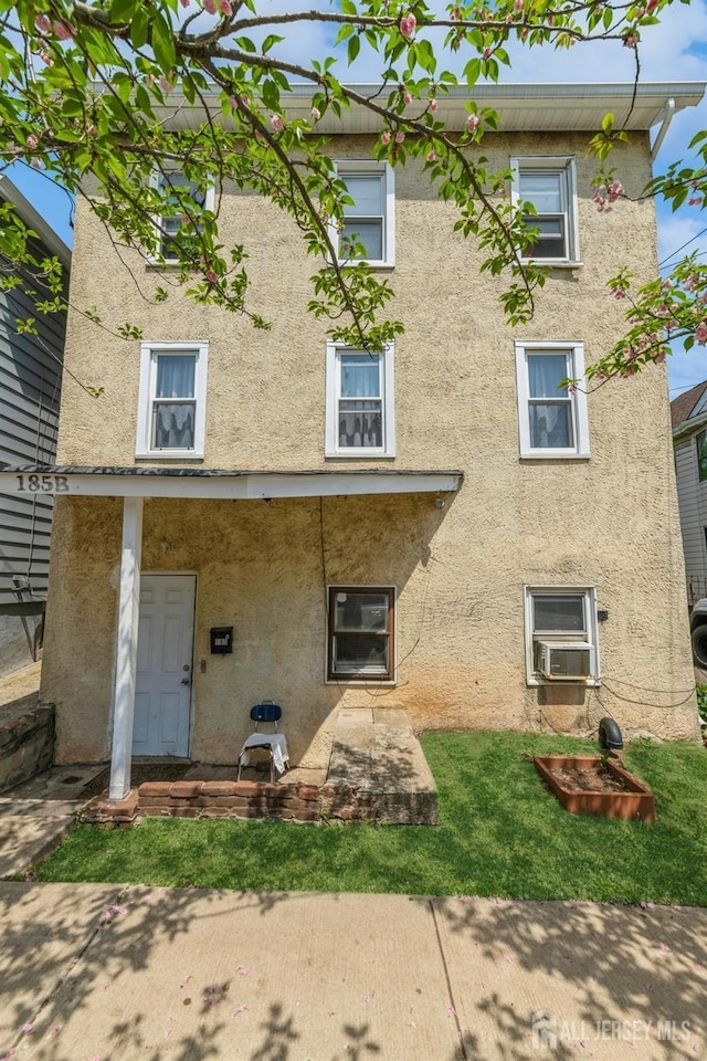 185 Redmond St, New Brunswick, NJ 08901 - back of property featuring stucco siding and cooling unit