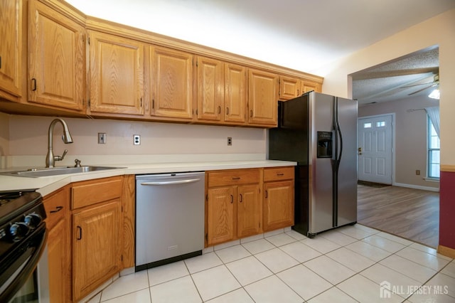 125 Albury Way N, Brunswick, NJ 08902 - kitchen featuring appliances with stainless steel finishes, a sink, light countertops, and brown cabinets