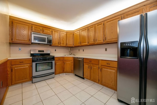 125 Albury Way N, Brunswick, NJ 08902 - kitchen featuring appliances with stainless steel finishes, a sink, light countertops, and brown cabinets