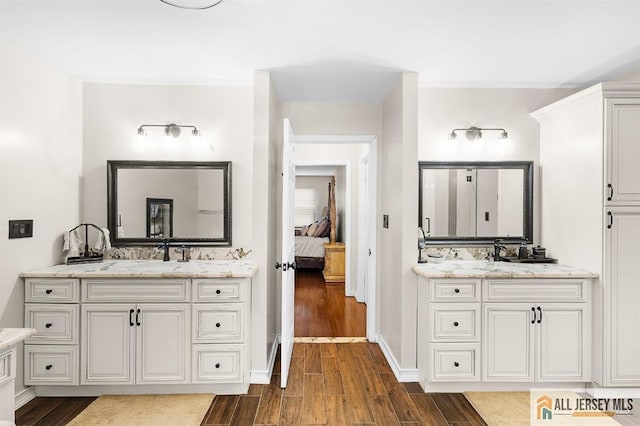 3 Eric Ct, Monroe, NJ 08831 - ensuite bathroom featuring wood finished floors, two vanities, and baseboards