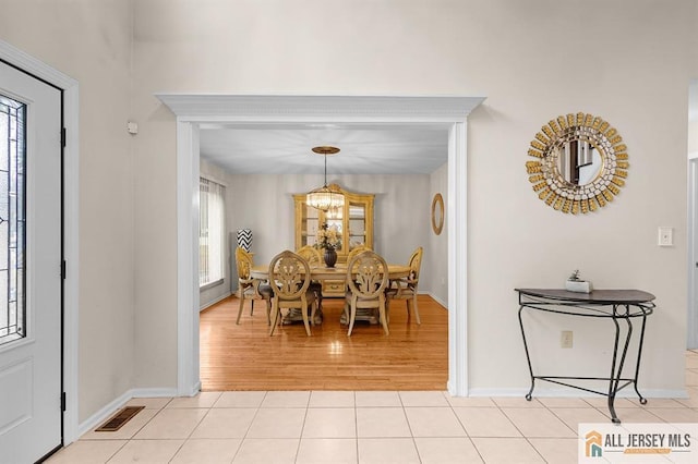 3 Eric Ct, Monroe, NJ 08831 - dining space with light tile patterned floors, baseboards, and a chandelier