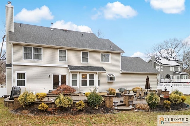3 Eric Ct, Monroe, NJ 08831 - rear view of house with a patio, a chimney, and roof with shingles
