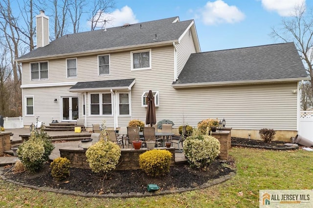3 Eric Ct, Monroe, NJ 08831 - back of property featuring a chimney, a patio, french doors, roof with shingles, and entry steps