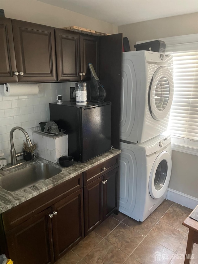 205 Water St, Perth Amboy, NJ 08861 - laundry room featuring stacked washing machine and dryer and a sink