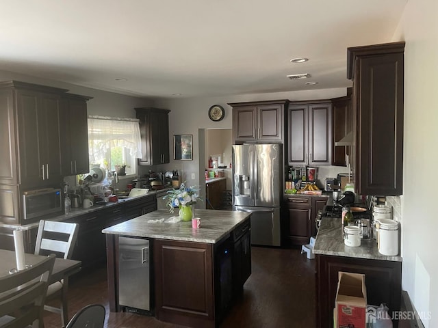 205 Water St, Perth Amboy, NJ 08861 - kitchen with appliances with stainless steel finishes, dark brown cabinetry, a kitchen island, dark wood-style flooring, and recessed lighting