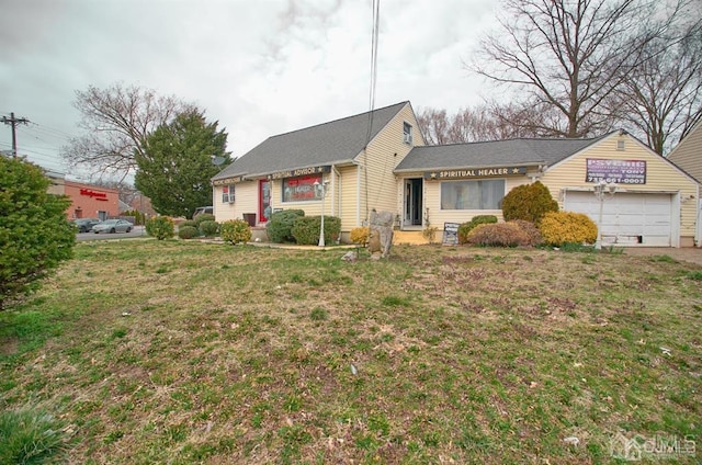 view of front of house with a front yard and a garage
