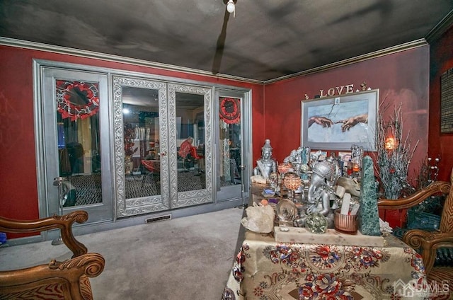 interior space with ornamental molding, carpet, and visible vents