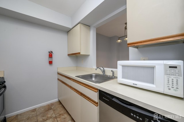 270 Main St Unit 6, Keansburg, NJ 07734 - kitchen with stainless steel dishwasher, white microwave, light countertops, and range