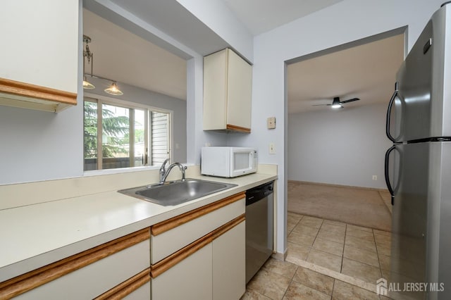 270 Main St Unit 6, Keansburg, NJ 07734 - kitchen featuring appliances with stainless steel finishes, light colored carpet, light countertops, white cabinets, and light tile patterned flooring