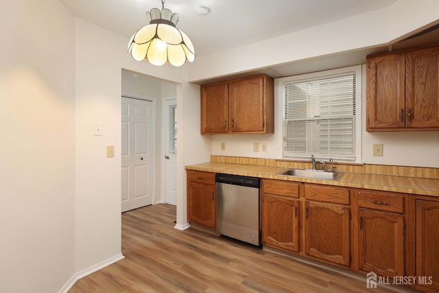 123-G Concordia Cir Unit G, Monroe, NJ 08831 - kitchen with stainless steel dishwasher, light wood-style floors, light countertops, and brown cabinets