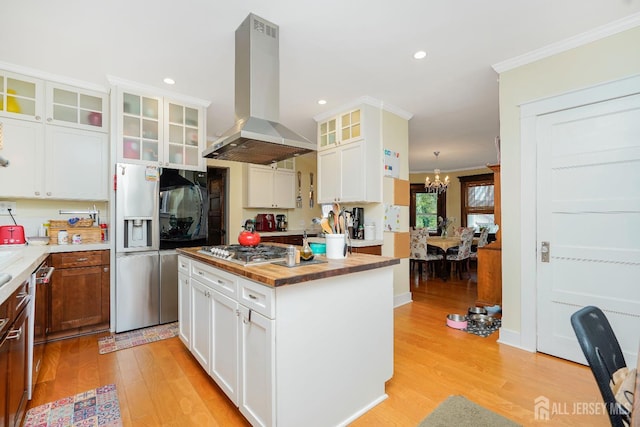 322 2nd St, Middlesex, NJ 08812 - kitchen with island range hood, stainless steel appliances, ornamental molding, a chandelier, and light wood-style floors