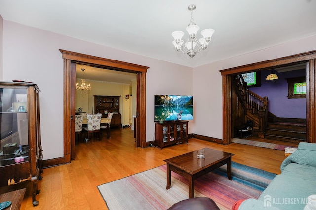 322 2nd St, Middlesex, NJ 08812 - living area featuring a chandelier, stairs, and light wood finished floors