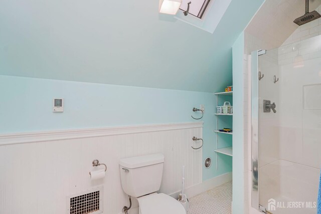 322 2nd St, Middlesex, NJ 08812 - bathroom with a stall shower, vaulted ceiling, a skylight, and tile patterned floors