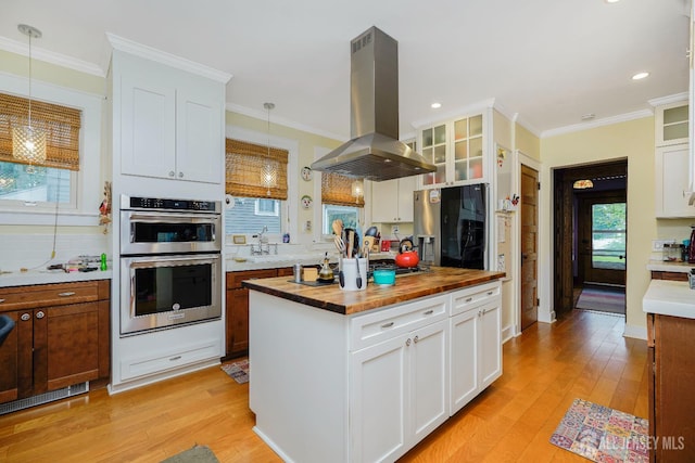 322 2nd St, Middlesex, NJ 08812 - kitchen with wooden counters, island range hood, refrigerator with ice dispenser, double oven, and light wood-type flooring