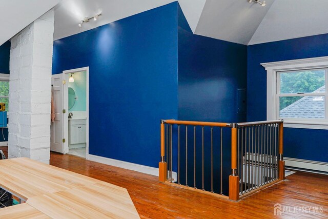 322 2nd St, Middlesex, NJ 08812 - interior space featuring track lighting, wood finished floors, plenty of natural light, baseboard heating, and high vaulted ceiling