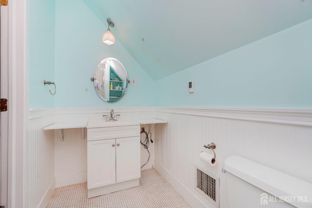 322 2nd St, Middlesex, NJ 08812 - bathroom featuring a wainscoted wall, lofted ceiling, and vanity