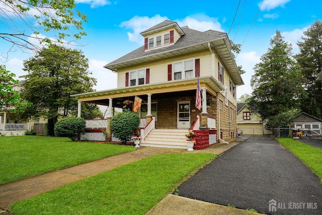 322 2nd St, Middlesex, NJ 08812 - american foursquare style home featuring a porch, a shingled roof, and an outdoor structure