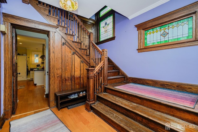 322 2nd St, Middlesex, NJ 08812 - staircase featuring wood finished floors and ornamental molding