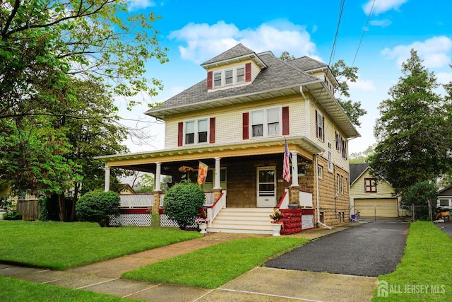 322 2nd St, Middlesex, NJ 08812 - traditional style home featuring covered porch, a garage, a front yard, an outdoor structure, and a shingled roof
