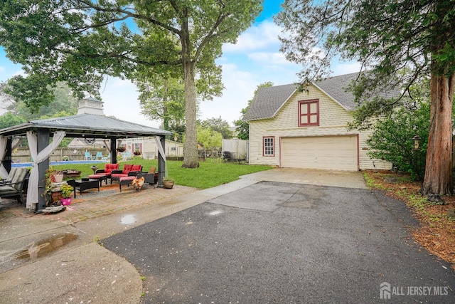 322 2nd St, Middlesex, NJ 08812 - view of grassy yard featuring asphalt driveway, a gazebo, an outdoor hangout area, and a garage