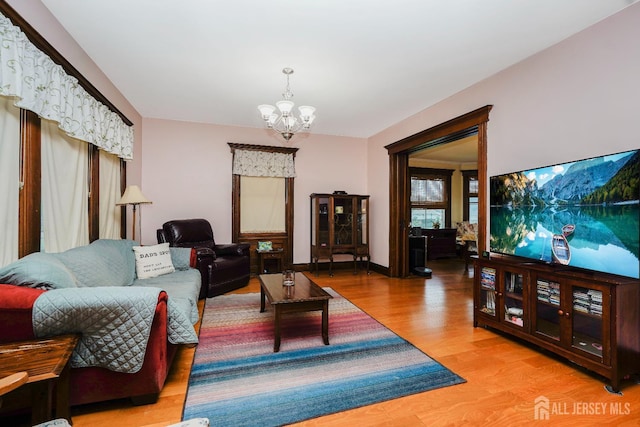 322 2nd St, Middlesex, NJ 08812 - living area with a chandelier and wood finished floors