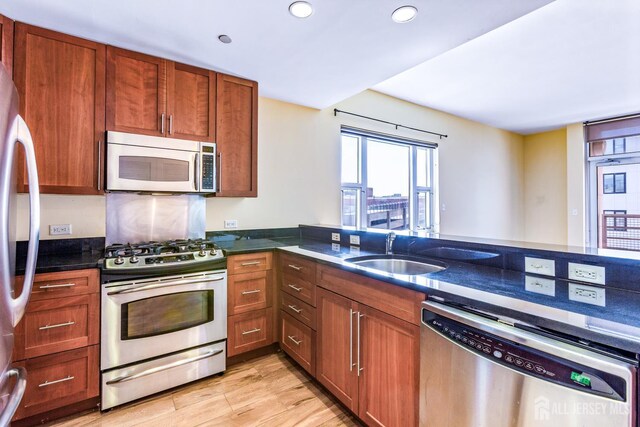 20 Livingston Ave Unit 902, New Brunswick, NJ 08901 - kitchen featuring stainless steel appliances, recessed lighting, dark stone countertops, light wood finished floors, and brown cabinets