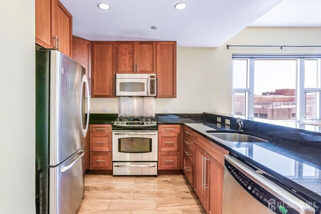 20 Livingston Ave Unit 902, New Brunswick, NJ 08901 - kitchen featuring stainless steel appliances, brown cabinetry, recessed lighting, dark stone countertops, and wood tiled floors