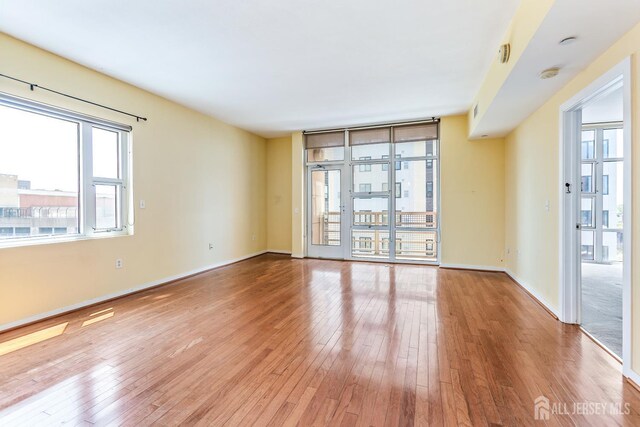 20 Livingston Ave Unit 902, New Brunswick, NJ 08901 - unfurnished room featuring wood-type flooring and a smoke detector