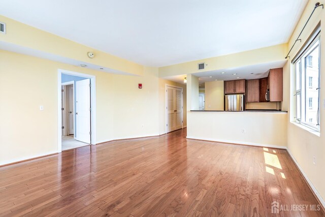 20 Livingston Ave Unit 902, New Brunswick, NJ 08901 - unfurnished living room with light wood finished floors