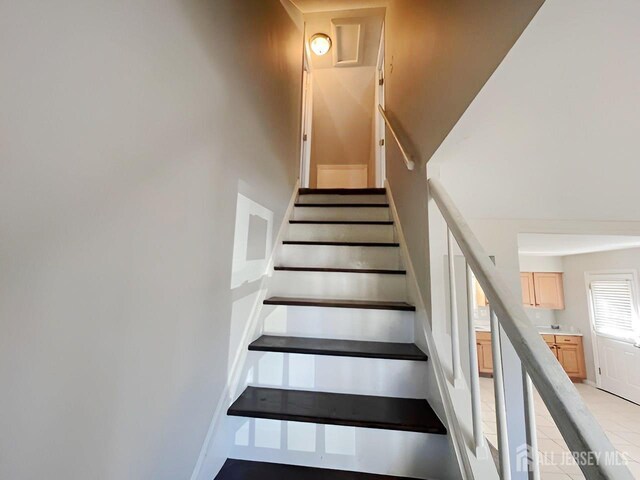 stairs with tile patterned flooring