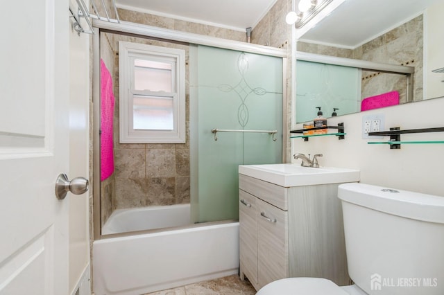 full bathroom featuring vanity, combined bath / shower with glass door, and toilet