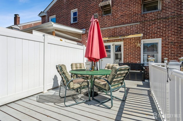 deck with fence and outdoor dining area
