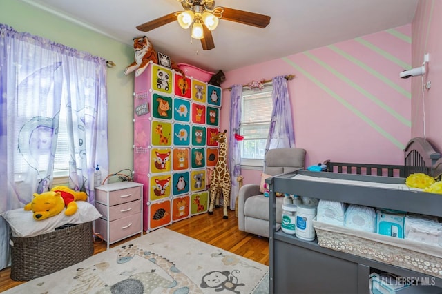 bedroom with ceiling fan and wood finished floors