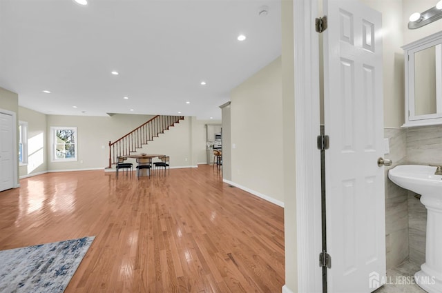 176 Easy St, Edison, NJ 08817 - unfurnished living room with stairs, light wood-type flooring, recessed lighting, and baseboards