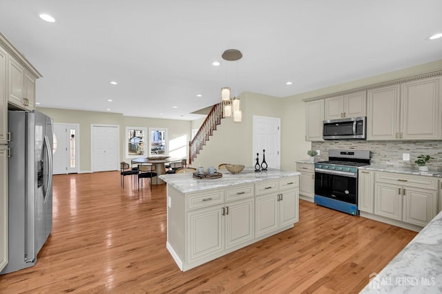 176 Easy St, Edison, NJ 08817 - kitchen with stainless steel appliances, light wood-style flooring, decorative backsplash, hanging light fixtures, and recessed lighting