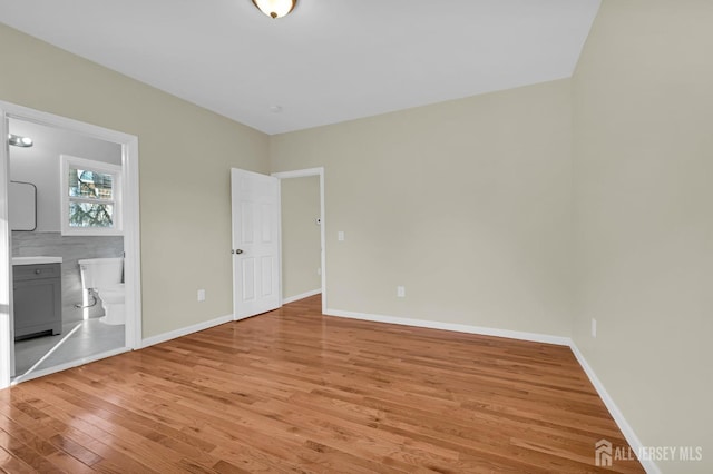 176 Easy St, Edison, NJ 08817 - unfurnished bedroom with light wood-type flooring, baseboards, and connected bathroom