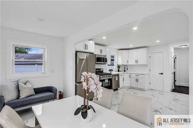 99 Crestview Rd, Fords, NJ 08863 - kitchen with stainless steel appliances, light marble finish floors, white cabinets, a sink, and recessed lighting