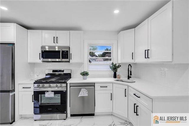 99 Crestview Rd, Fords, NJ 08863 - kitchen featuring stainless steel appliances, a sink, light marble finish flooring, light countertops, and white cabinets