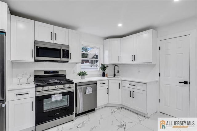 99 Crestview Rd, Fords, NJ 08863 - kitchen featuring stainless steel appliances, a sink, light marble finish flooring, light countertops, and white cabinetry