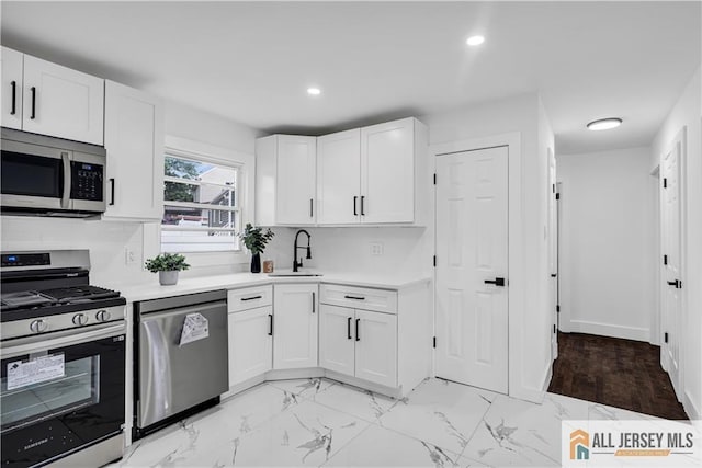 99 Crestview Rd, Fords, NJ 08863 - kitchen featuring stainless steel appliances, light countertops, white cabinetry, a sink, and recessed lighting