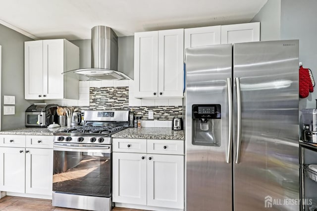 16 Kerschner Ln, East Brunswick, NJ 08816 - kitchen featuring appliances with stainless steel finishes, wall chimney range hood, light stone countertops, white cabinets, and tasteful backsplash