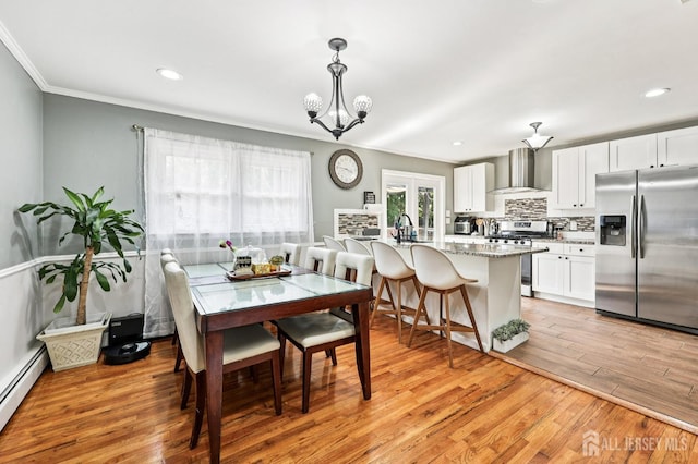 16 Kerschner Ln, East Brunswick, NJ 08816 - dining area with a baseboard radiator, ornamental molding, light wood finished floors, recessed lighting, and a chandelier
