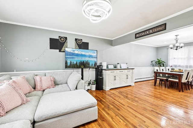 16 Kerschner Ln, East Brunswick, NJ 08816 - living area with a chandelier, a baseboard radiator, light wood-style floors, crown molding, and a baseboard heating unit