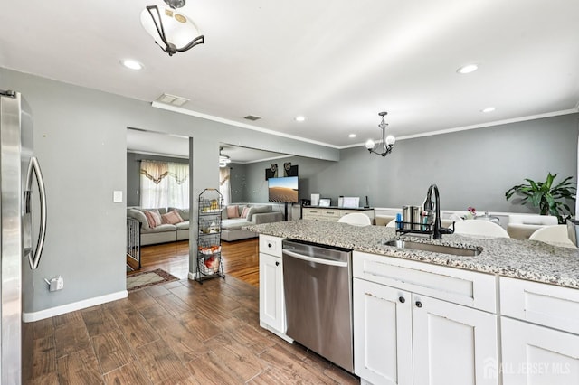 16 Kerschner Ln, East Brunswick, NJ 08816 - kitchen with stainless steel appliances, a chandelier, white cabinets, recessed lighting, and light stone countertops