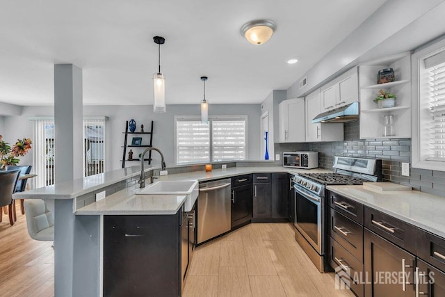 904 4th St, Union Beach, NJ 07735 - kitchen featuring under cabinet range hood, stainless steel appliances, a sink, and a healthy amount of sunlight