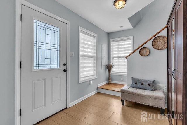 904 4th St, Union Beach, NJ 07735 - entryway featuring baseboards, light wood-style floors, and plenty of natural light