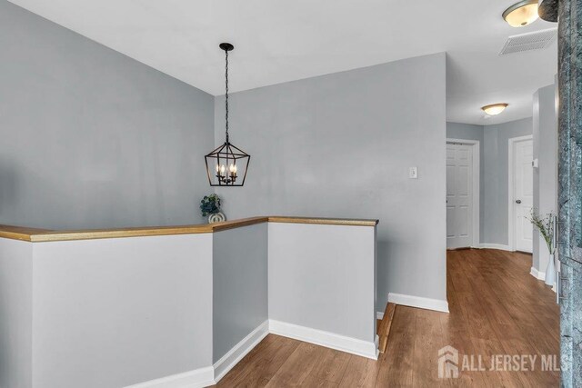 904 4th St, Union Beach, NJ 07735 - interior space with baseboards, an inviting chandelier, visible vents, and wood finished floors